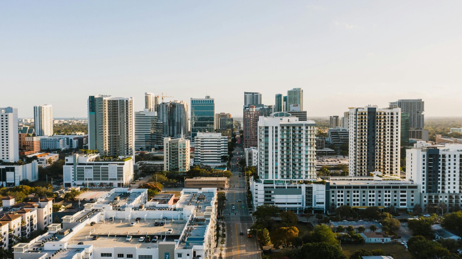 Scenic cityscape of Fort Lauderdale downtown with modern multistory buildings and glass skyscrapers against cloudless sunset sky